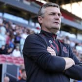 Bristol City manager Michael Skubala stands with his arms folded on the touchline
