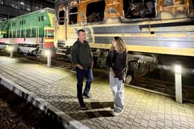 Stuart Anderson MP outside a recently damaged passenger train in Kyiv, Ukraine