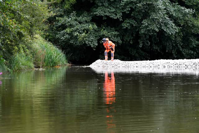 Workmen build a temporary dam at the scene of the canal collapse in Whitchurch in readiness to drain part of the canal to find where there is a breach. Tim Thursfield/Iconic Media Group