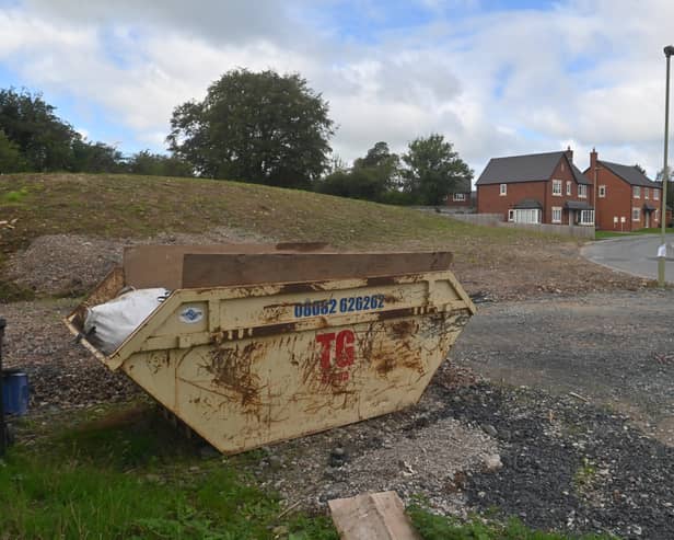The large mound of earth and space used to store construction equipment which was supposed to be ‘green space’.