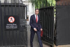 Ed Miliband walks through a gated entrance to Downing Street