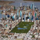 Central Park and the tall buildings of midtown Manhattan are seen on a large model of New York City, made by Joe Macken