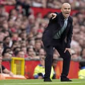 Manchester City manager Enzo Maresca crouches on the touchline