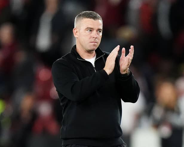 Bolton manager Steven Schumacher applauds the fans