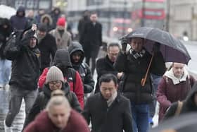 Commuters battle with the wintry conditions on London Bridge