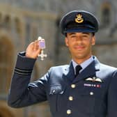Chris Gordon in uniform holding up a medal
