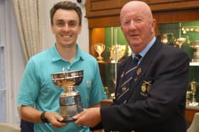 Josh Charnock is presented with the County Open Championship trophy by Shropshire & Herefordshire president Nigel Chesters