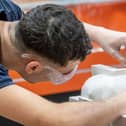 Apprentices working in various building trades including carpentry, brick laying, joinery, tiling , plastering, masonry and decorating