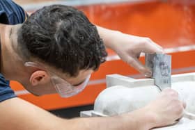 Apprentices working in various building trades including carpentry, brick laying, joinery, tiling , plastering, masonry and decorating