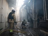 Rescue workers put out a fire of the central market damaged in a Russian strike on Zaporizhzhia, Ukraine