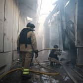 Firefighters tackle a blaze in a war-damaged building