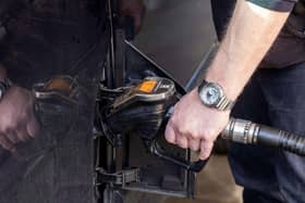 A person fills up a vehicle with diesel