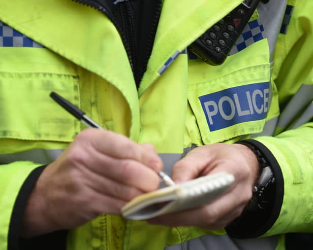 A police officer writes in a notebook