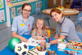 Maisie with staff at the hospital's Alice Ward.