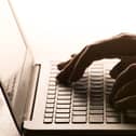 Hands on a laptop keyboard