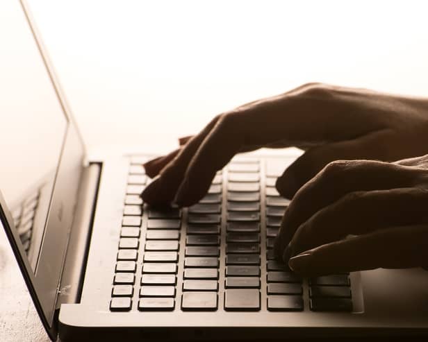 Hands on a laptop keyboard