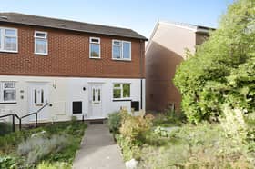 The front garden and pathway provide a welcoming approach to this two-bedroom Shrewsbury home, with allocated parking beyond