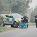 Police, vehicle and stop sign near Fairford incident
