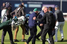 Celtic principal shareholder Dermot Desmond (centre) being escorted off by security from the 18th green on day three of the 2026 Alfred Dunhill Links Championship at St Andrews