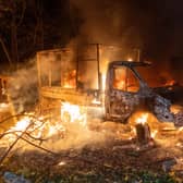 A car burns after a Russian drone strike on a residential area in Kharkiv