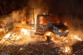 A car burns after a Russian drone strike on a residential area in Kharkiv
