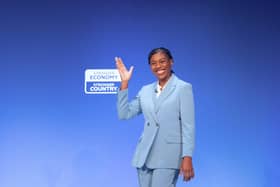 Kemi Badenoch waves on stage at the Conservative Party conference 2026
