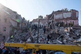 Locals and rescuers clear the rubble of a residential building destroyed in a Russian missile strike on Pryluky, Ukraine