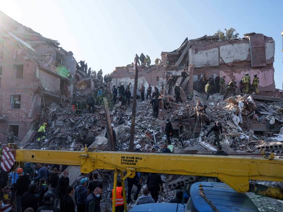 Locals and rescuers clear the rubble of a residential building destroyed in a Russian missile strike on Pryluky, Ukraine