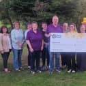 Members of the Penybont and District Charity Committee presenting the donation to Tori Williams of Marie Curie 