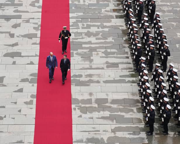 German Chancellor Friedrich Merz and British Prime Minister Andy Burnham walk on the red carpet during a meeting at the Chancellery in Berlin