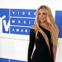 Britney Spears in a black gown, posing for a photos