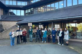 Supporters of Gladestry Primary School with their banners at Powys County Council's headquarters for the full council meeting yesterday