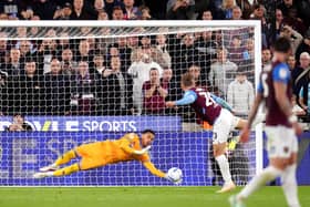 QPR goalkeeper Pierce Charles makes a save from a penalty kick