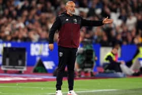 West Ham manager Nuno Espirito Santo gestures with his left arm outstretched on the touchline against QPR