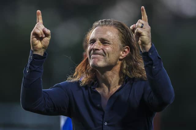 Gillingham manager Gareth Ainsworth celebrates in his familiar style.
