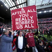 Liverpool fans hold up a large banner