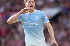 Manchester City’s Elliot Anderson presses a finger close to his ear