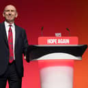John Healey at the side of a lectern at the Labour Party conference
