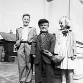 Billy Lloyd in front of Dawley’s Captain Webb Memorial with two unidentified children.