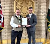 The Chair of Powys County Council, Cllr Geoff Morgan, presents the Defence Employer Recognition Scheme Gold Award to Deputy Leader and Armed Forces Champion, Cllr Matthew Dorrance.