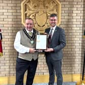 The Chair of Powys County Council, Cllr Geoff Morgan, presents the Defence Employer Recognition Scheme Gold Award to Deputy Leader and Armed Forces Champion, Cllr Matthew Dorrance.