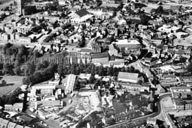 PICTURE FROM THE ARCHIVE: This aerial photograph captures the changing skyline of Whitchurch in 1978. Key landmarks of the Shropshire market town stand out clearly across the townscape: the historic St Alkmund's Church dominates the top left, the bustling Smithfield market occupies the top right, and the town's local dairy site is visible in the bottom left. Do you recognise any of your favourite streets or buildings in this 1970s view of the town?