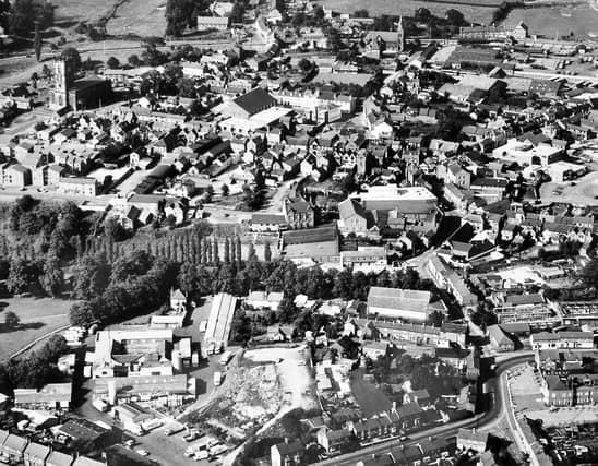 PICTURE FROM THE ARCHIVE: This aerial photograph captures the changing skyline of Whitchurch in 1978. Key landmarks of the Shropshire market town stand out clearly across the townscape: the historic St Alkmund's Church dominates the top left, the bustling Smithfield market occupies the top right, and the town's local dairy site is visible in the bottom left. Do you recognise any of your favourite streets or buildings in this 1970s view of the town?