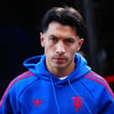A scowling Lisandro Martinez arrives for a Manchester United match