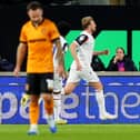 Dejected Wolves men Adam Armstrong (left) and Hugo Bueno (right) as Sam Dalby celebrates scoring for Bolton