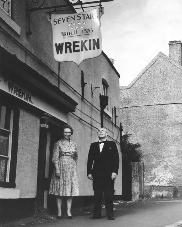 Mr and Mrs Richard Tart, hosts of the Seven Stars, in 1961, admiring the familiar sign proudly displaying the date on which ale was first drawn at the 16th century inn.