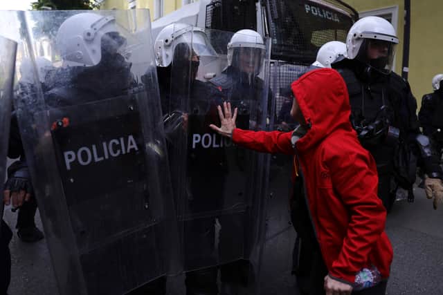A protester pushes a riot police officer’s shield during an anti-government demonstration in Tirana (Hameraldi Agolli/AP)