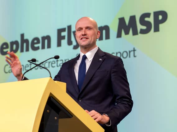 Stephen Flynn speaking at a lectern