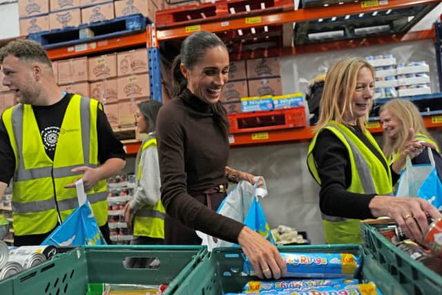 Meghan helps pack a food parcel during a visit to Himmah Hub in Nottingham (Annabel Lee-Ellis/PA)