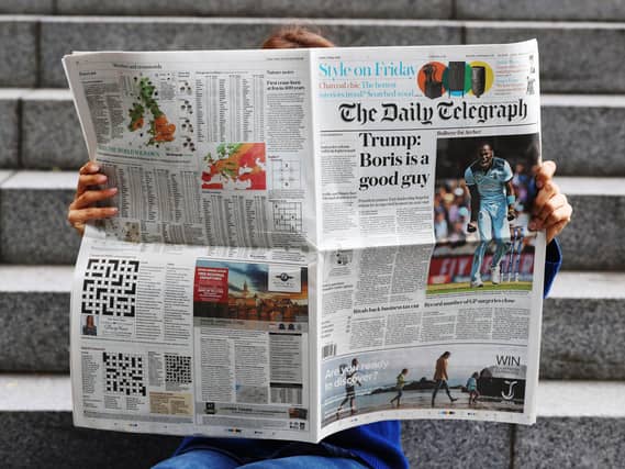 A person reading the Daily Telegraph